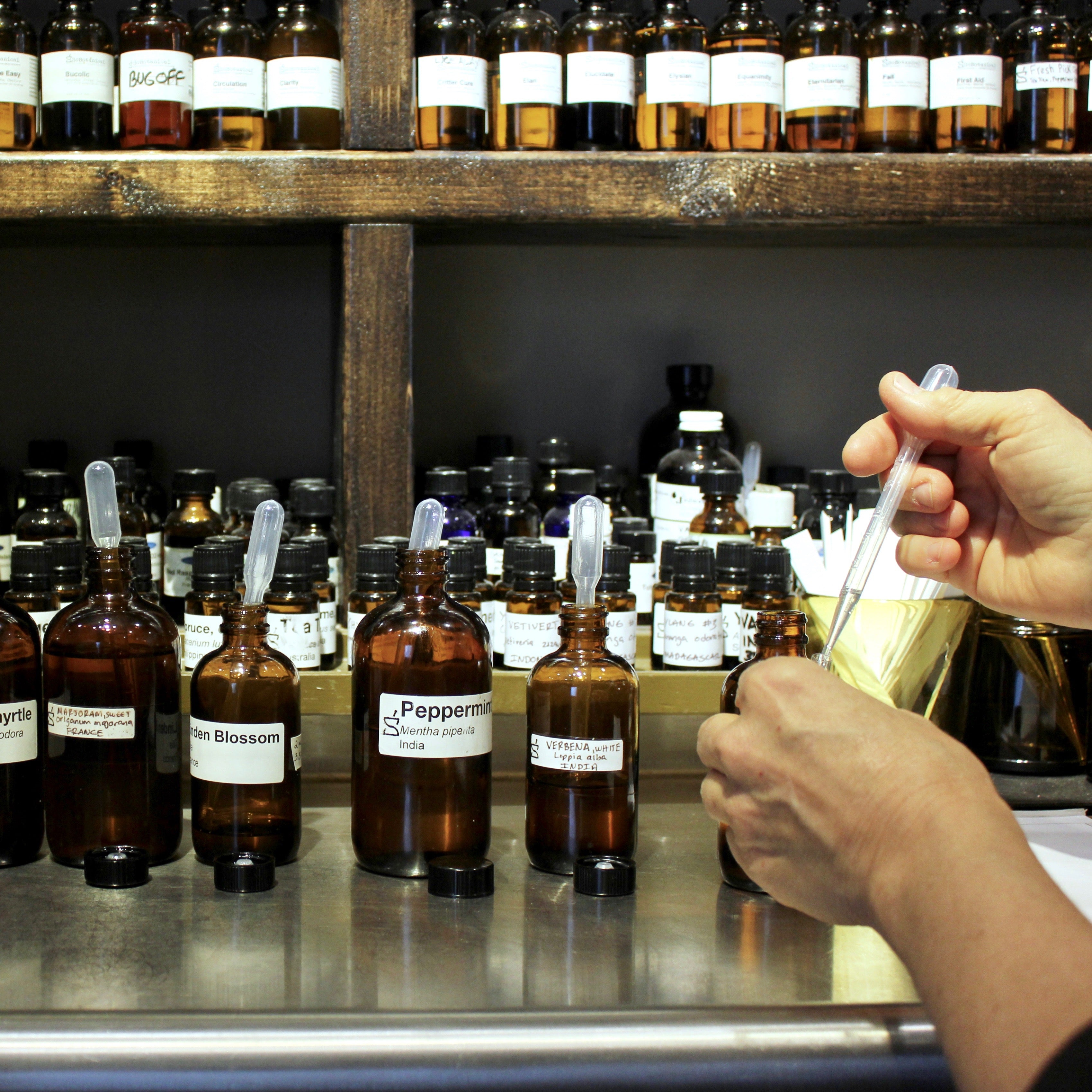 Essential oils being blended by hand in the SoBotanical studio