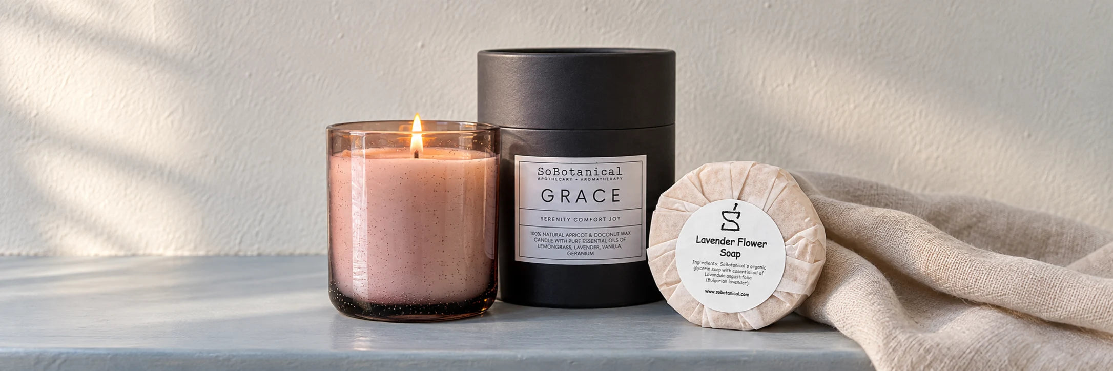 Grace candle and Lavender Flower Soap beside linen