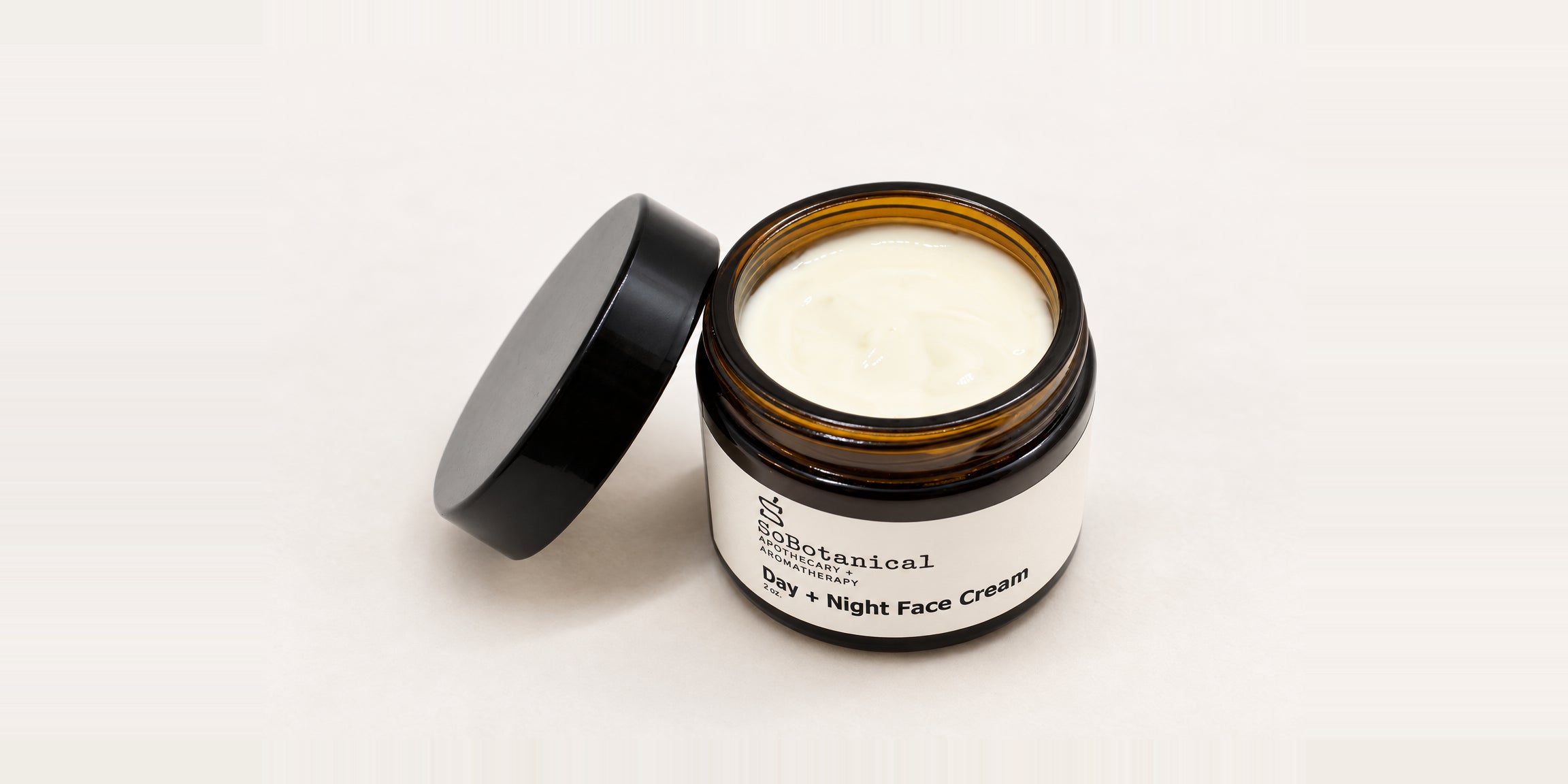 Open Day + Night Face Cream jar with its creamy texture visible