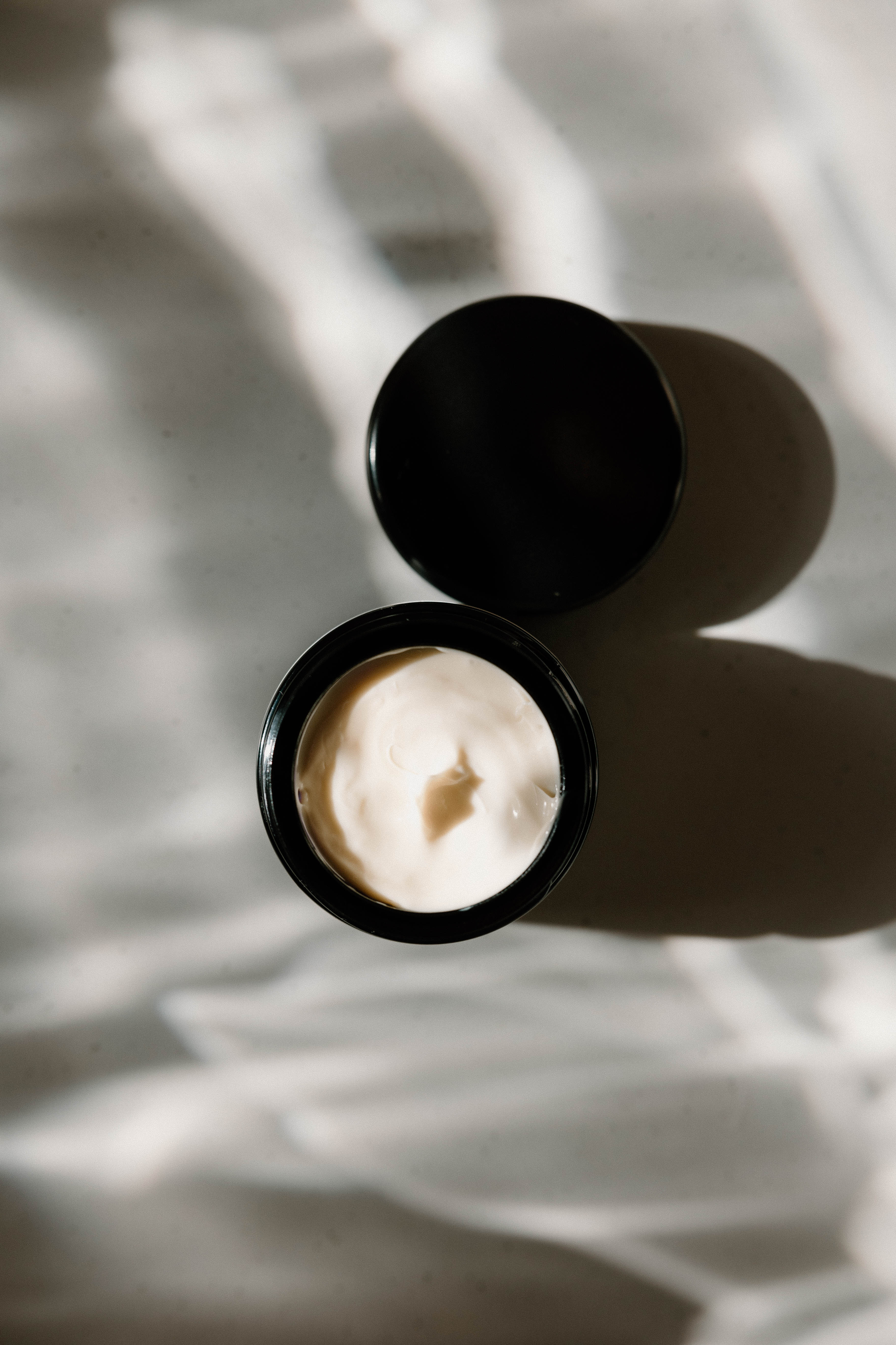 Moisture Extreme Cream, an open jar in soft studio light